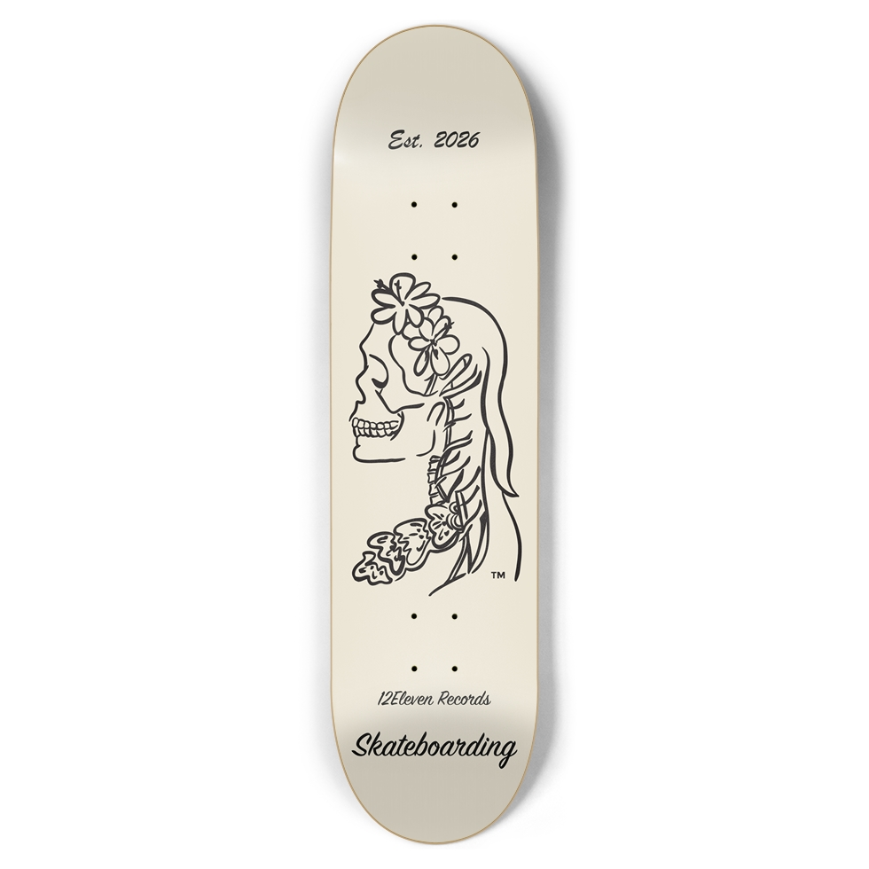 Skateboard deck with a design of a skull face with flowers and the text 'Est. 2026' on a white background.